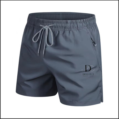 A pair of men's athletic shorts in slate gray, featuring a matching gray elastic waistband with a silver-and-white patterned drawstring, a side zip pocket, and a black 'Della of A' logo printed on the lower left leg.